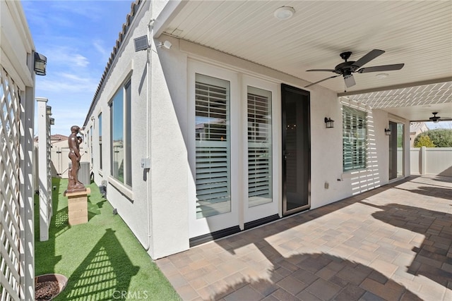 view of patio with ceiling fan and fence