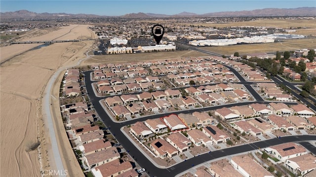 drone / aerial view featuring a residential view and a mountain view