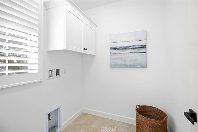 laundry area featuring hookup for a washing machine, cabinet space, and baseboards