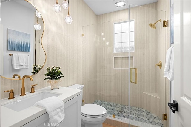 full bathroom with toilet, a stall shower, visible vents, and vanity