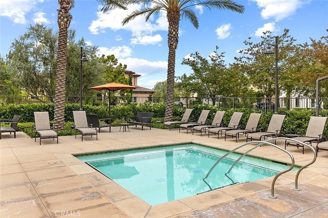 view of pool featuring a patio area and fence