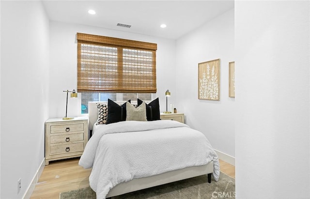 bedroom featuring recessed lighting, visible vents, light wood finished floors, and multiple windows