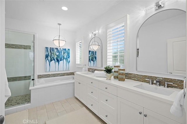 full bathroom featuring double vanity, tiled shower, a garden tub, tile patterned flooring, and a sink