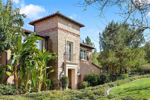 view of side of property with stone siding and stucco siding