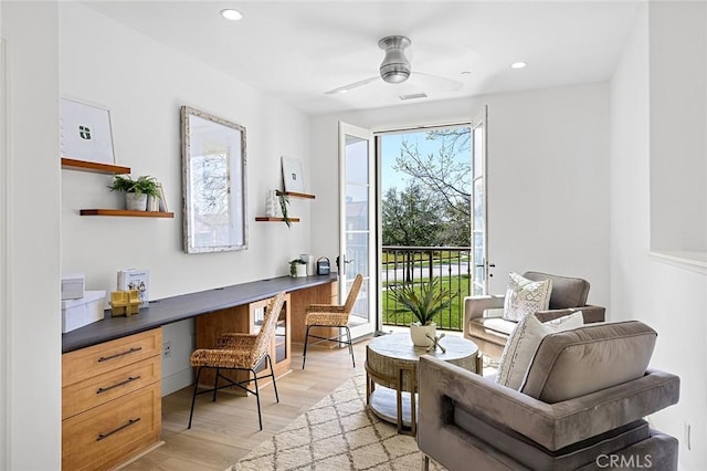 living area with ceiling fan, recessed lighting, visible vents, light wood-style floors, and built in study area