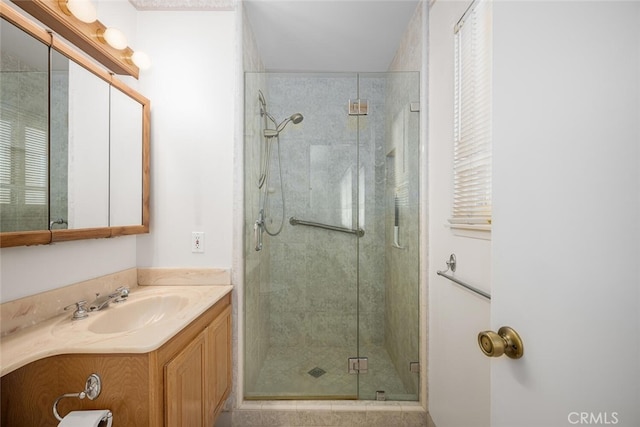 full bath featuring a stall shower and vanity