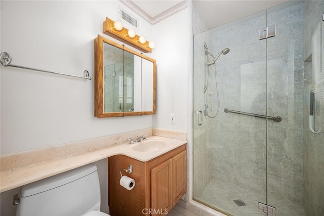 bathroom with toilet, a shower stall, visible vents, and vanity