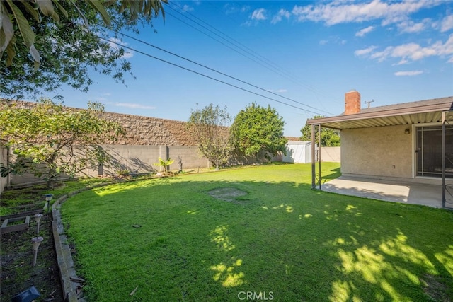 view of yard with a patio area and a fenced backyard