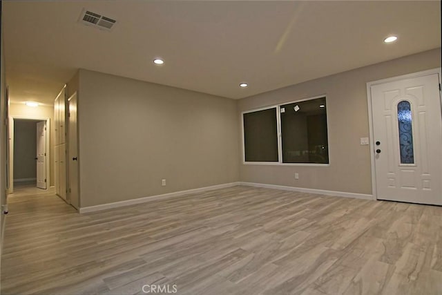 entrance foyer with recessed lighting, visible vents, light wood-style flooring, and baseboards