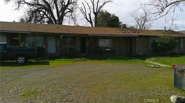 exterior space featuring driveway and a front lawn