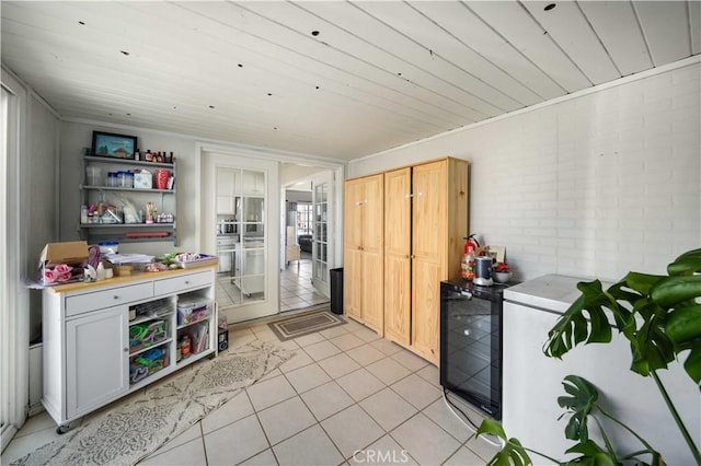 kitchen with light tile patterned floors, light countertops, open shelves, and light brown cabinets