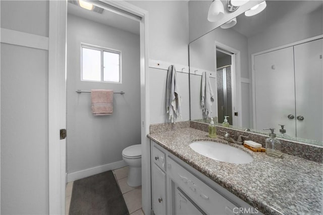 full bathroom featuring toilet, baseboards, vanity, and tile patterned floors