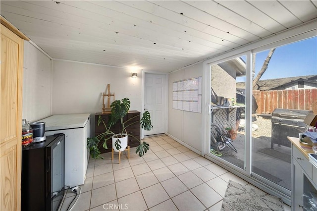 interior space with wood ceiling and light tile patterned flooring