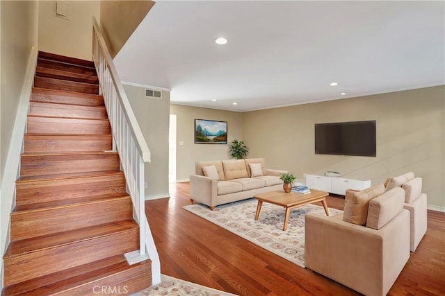 living room featuring stairway, wood finished floors, visible vents, and recessed lighting