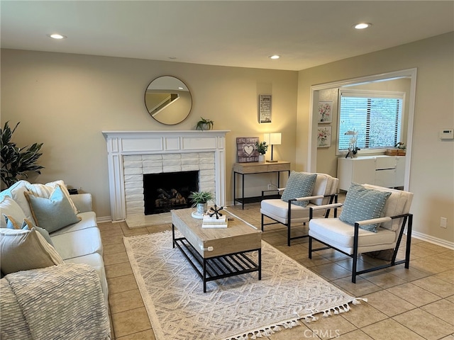 living area featuring light tile patterned floors, recessed lighting, baseboards, and a tile fireplace