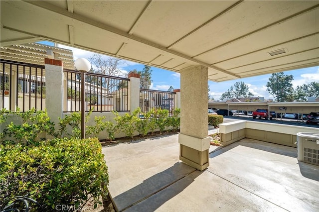 view of patio / terrace with central AC unit and fence