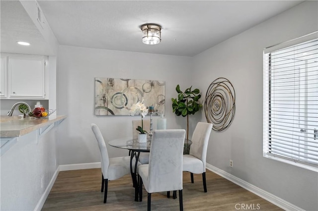 dining space with light wood-style floors and baseboards