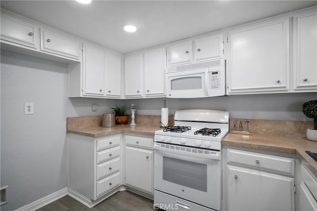 kitchen featuring white appliances and white cabinetry