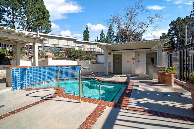 view of swimming pool with a pool, a patio area, fence, and a pergola