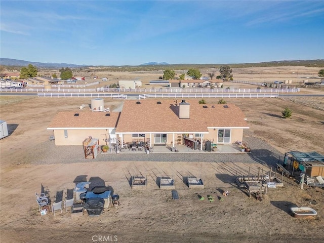 drone / aerial view featuring a mountain view and a rural view