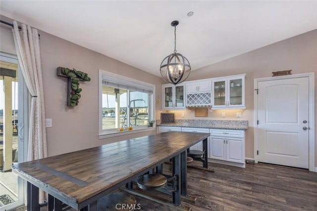 kitchen featuring glass insert cabinets, dark wood finished floors, white cabinets, and vaulted ceiling