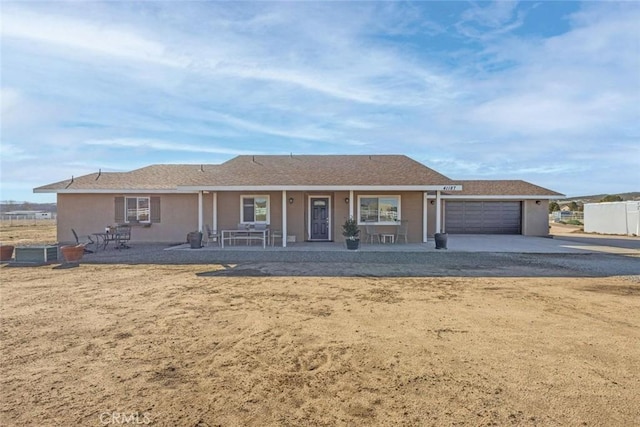 single story home with a garage and stucco siding