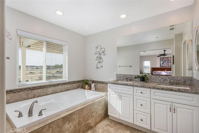 full bathroom featuring ensuite bathroom, a sink, and a wealth of natural light