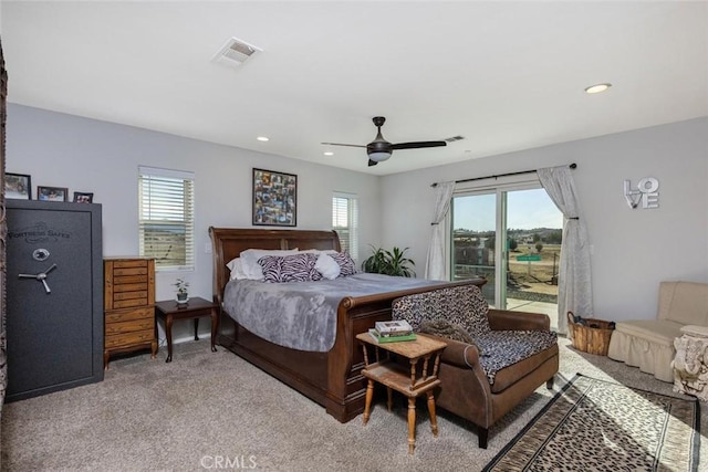 carpeted bedroom featuring access to outside, multiple windows, visible vents, and ceiling fan