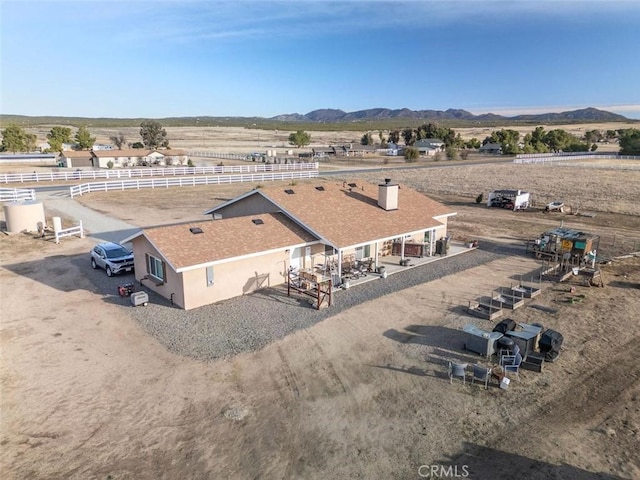 birds eye view of property featuring a mountain view and a rural view