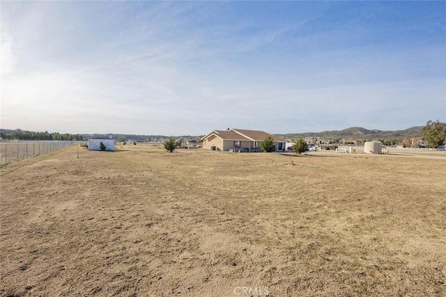 view of yard featuring a rural view and fence