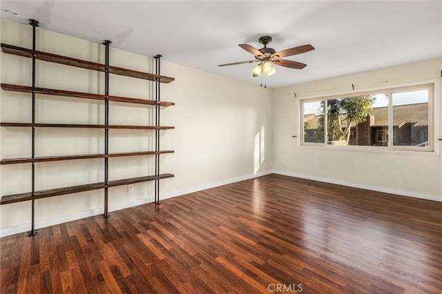 unfurnished room featuring ceiling fan, baseboards, and wood finished floors