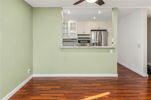 kitchen with white cabinets, glass insert cabinets, stainless steel appliances, and dark wood finished floors