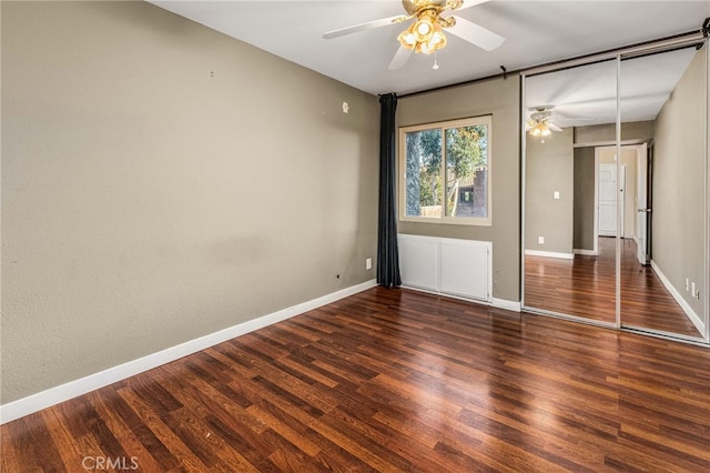 unfurnished bedroom featuring wood finished floors, a ceiling fan, and baseboards