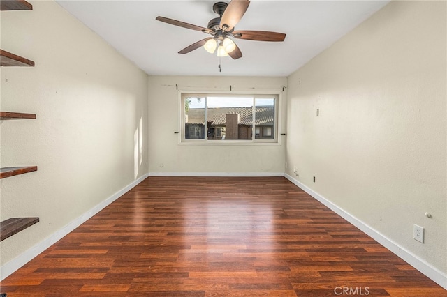 empty room featuring ceiling fan, wood finished floors, and baseboards