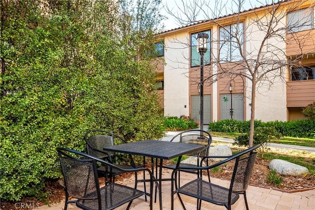 view of patio featuring outdoor dining area