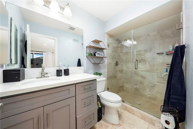 bathroom with a stall shower, visible vents, vanity, and toilet