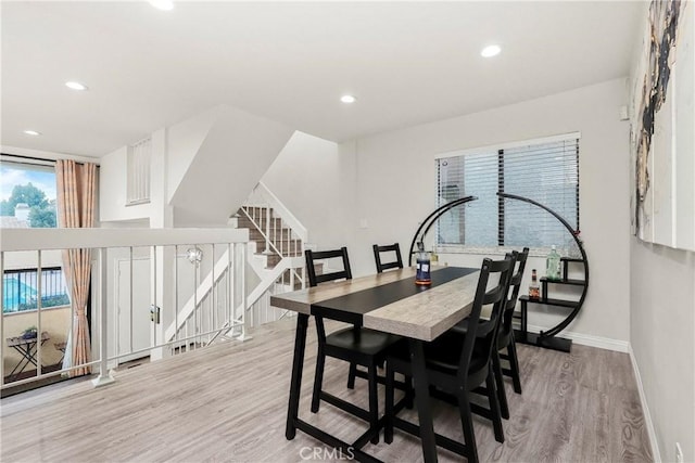 dining room featuring baseboards, stairway, recessed lighting, and light wood-style floors