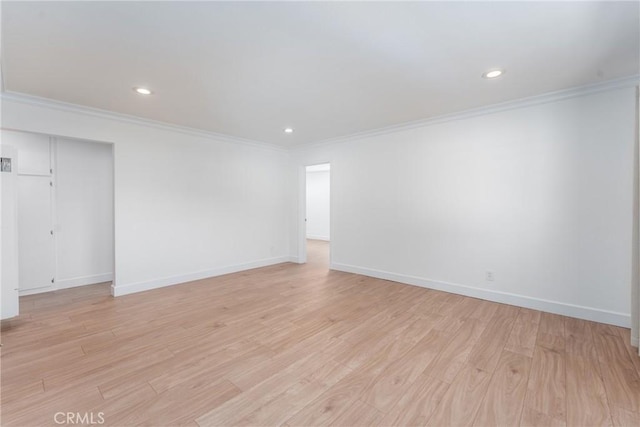 unfurnished room with light wood-style floors and ornamental molding