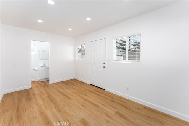 interior space featuring baseboards, recessed lighting, and light wood-style floors