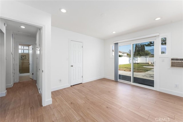 unfurnished room with baseboards, a wealth of natural light, light wood-style flooring, and recessed lighting