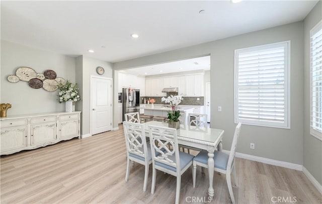 dining space with light wood-style flooring, baseboards, and recessed lighting