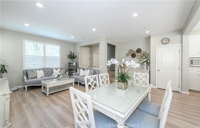 dining space with light wood-type flooring, baseboards, and recessed lighting