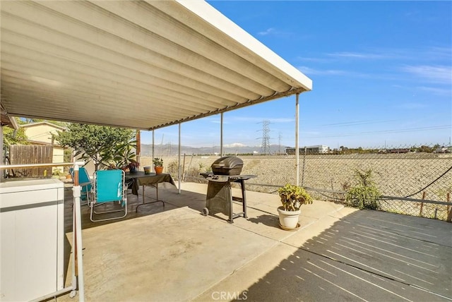 view of patio / terrace featuring outdoor dining space, fence, and grilling area