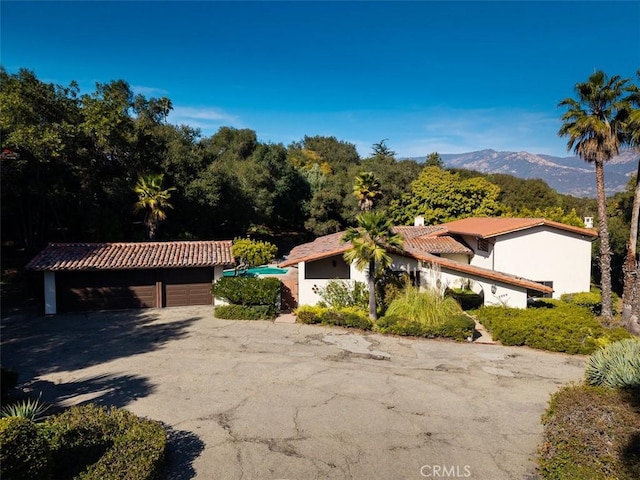 exterior space featuring a garage and a mountain view