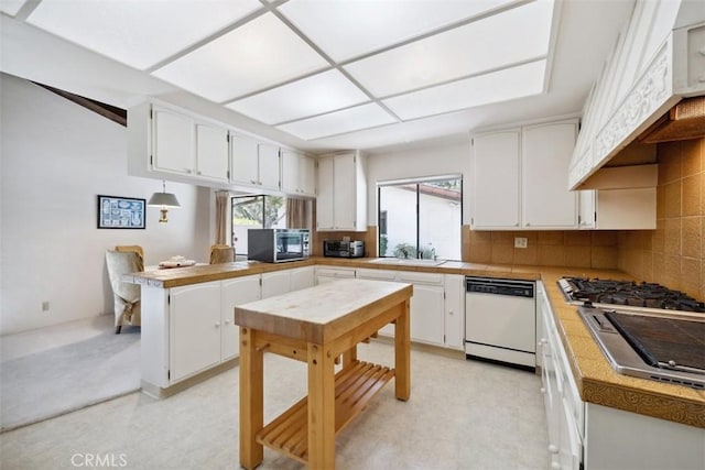 kitchen featuring stainless steel appliances and white cabinetry