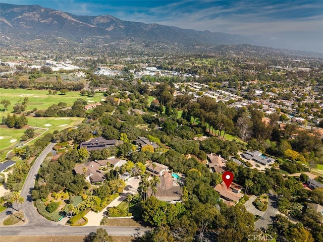 drone / aerial view with a mountain view and golf course view