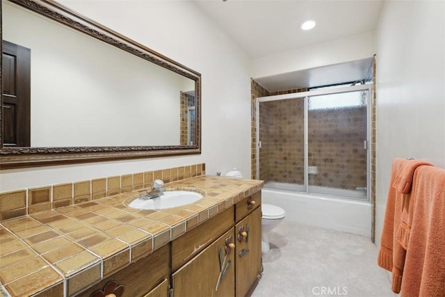 bathroom with toilet, shower / bath combination with glass door, and vanity