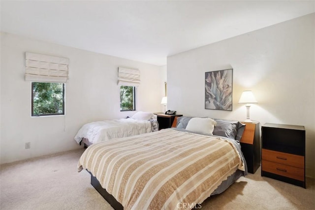 bedroom featuring light colored carpet