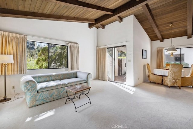 living area with high vaulted ceiling, beamed ceiling, wooden ceiling, and carpet flooring