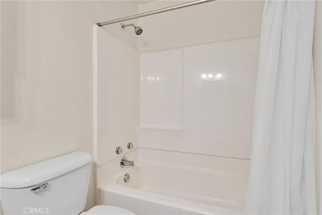 bathroom with toilet and shower / bath combination with curtain